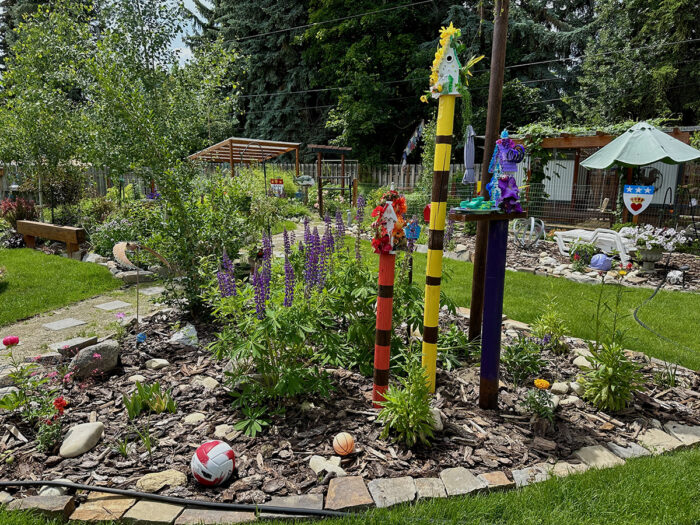 colorful birdhouses on poles